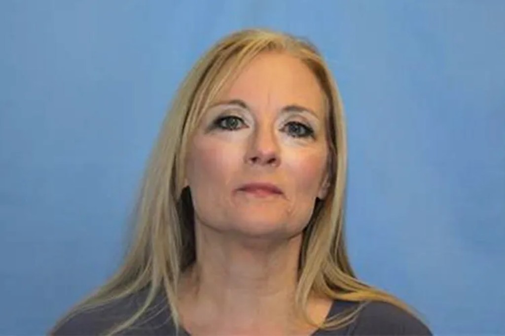 Mugshot of a woman, Tamara Hambry, with blonde hair and a blue background.
