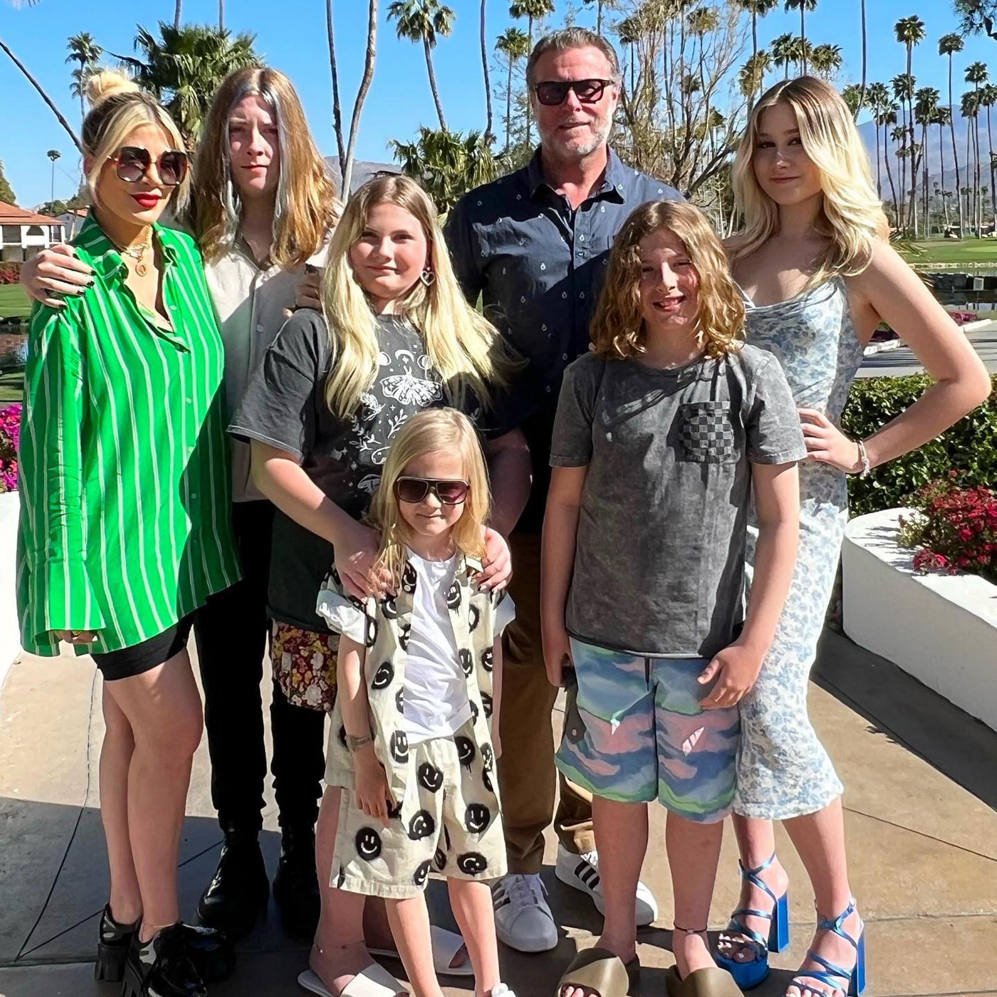 Tori Spelling, Dean McDermott and their five children pose together outdoors.