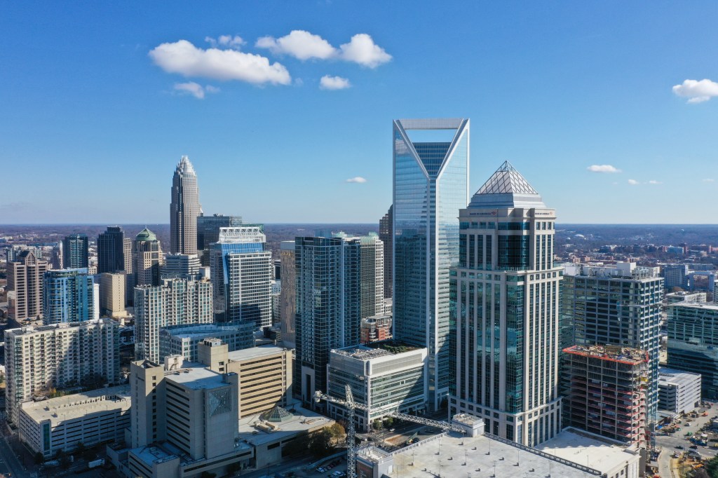 Charlotte, North Carolina skyline with skyscrapers under a blue sky.