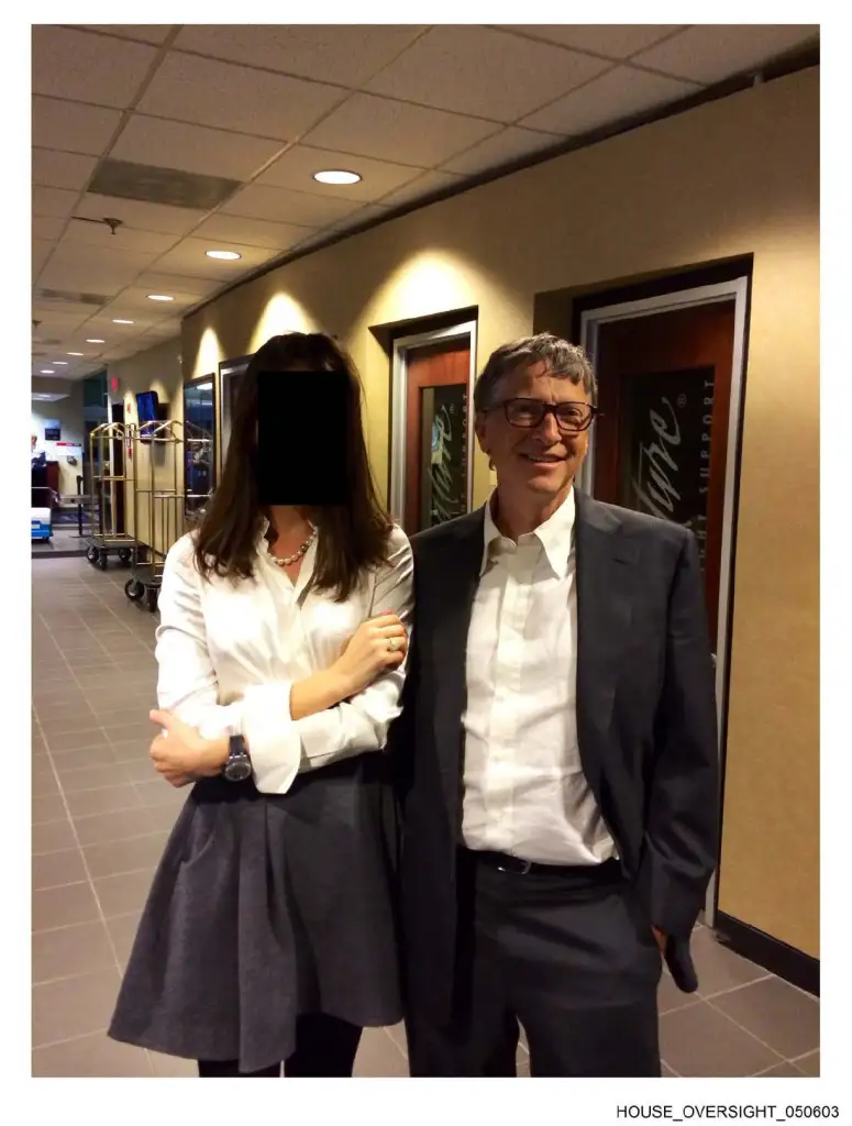 A woman with her face blurred and Bill Gates posing for a photo.