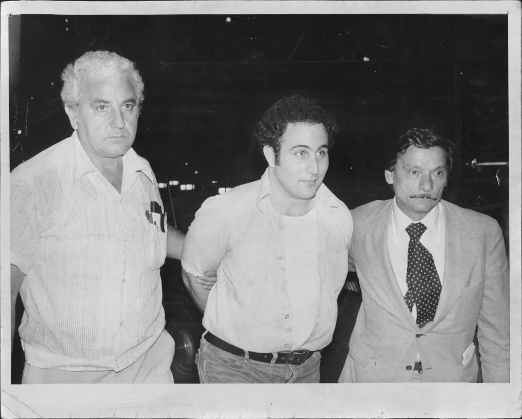 David Berkowitz (center) being escorted by two detectives.