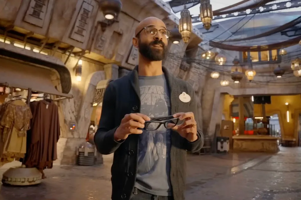 Asa Kalama holding AI glasses. 