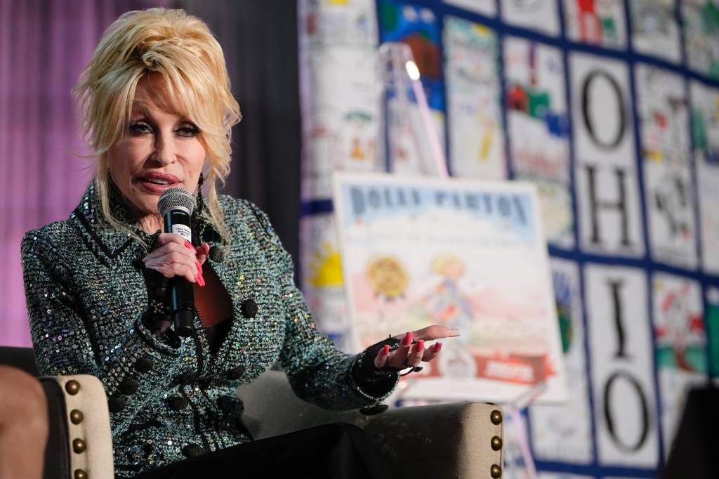 Dolly Parton speaking into a microphone.