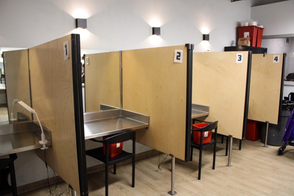 Inside an OnPoint NYC facility with multiple booths.