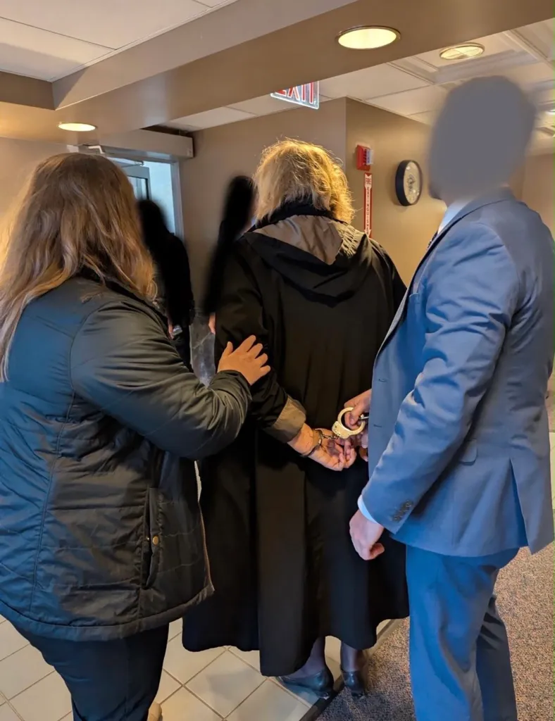 Dugan is escorted by officials after her arrest, in Milwaukee, Wisconsin, U.S., April 25, 2025.