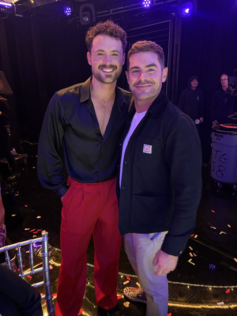 Dylan and Zac Efron smiling for a photo.