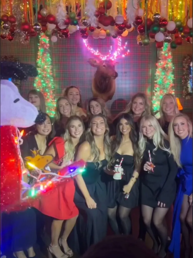 Group photo of women including Taylor Swift at a Christmas party.