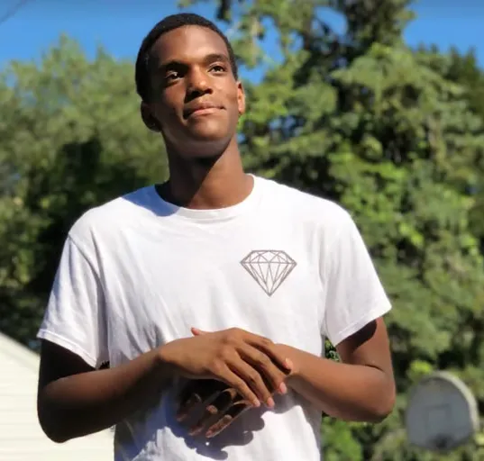 Edeedson Cine in a white t-shirt.