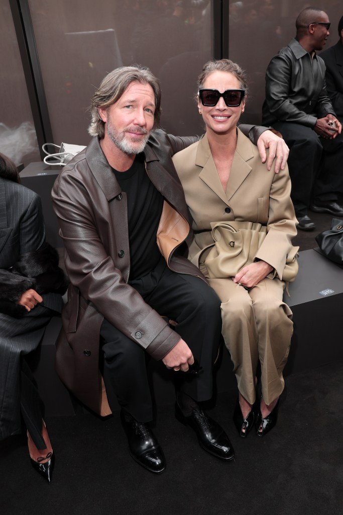 Edward Burns and Christy Turlington sitting at the Ferragamo SS26 show.