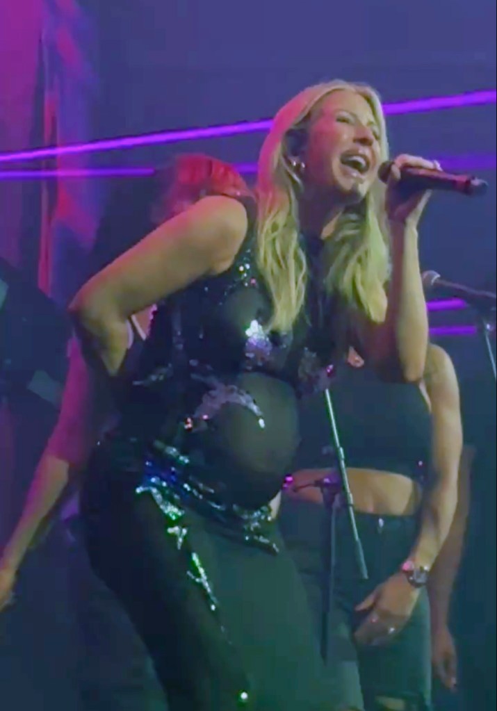 Ellie Goulding performing while pregnant in a sheer sequined outfit.