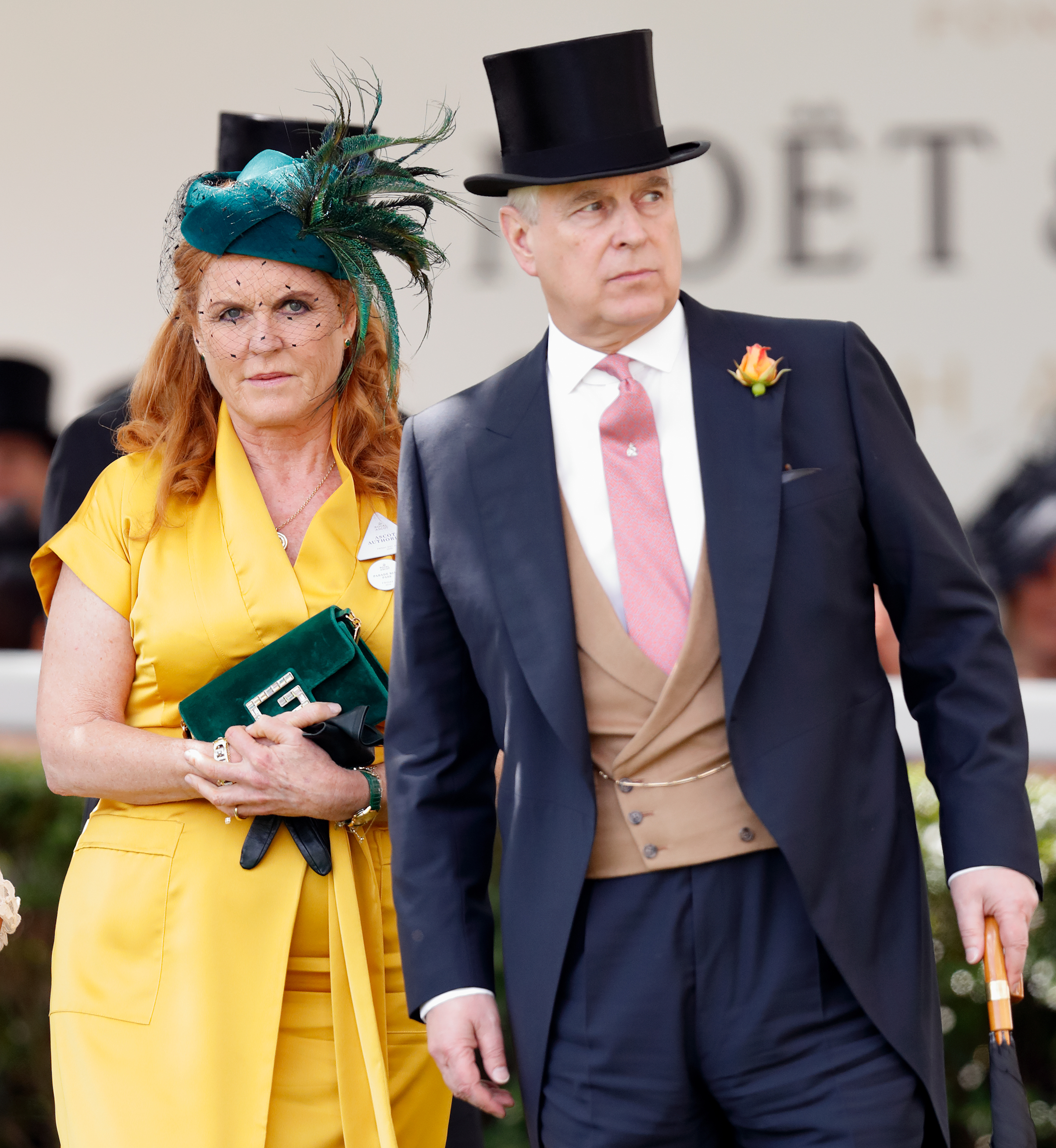 Sarah Ferguson, Duchess of York, in a yellow dress and a feathered teal hat, and Prince Andrew, Duke of York, in a dark suit and top hat.