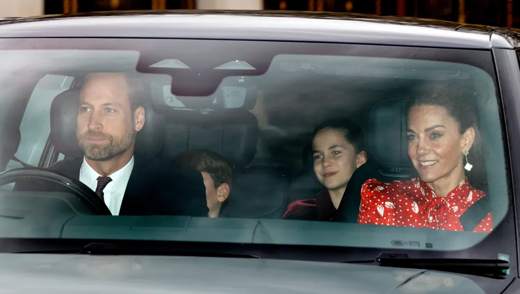 Prince William driving a car with Princess Charlotte and Princess Catherine as passengers.