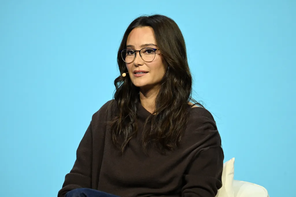 Emma Heming Willis wearing glasses and a dark brown top, speaking at the End Well Project 2025 Conference.