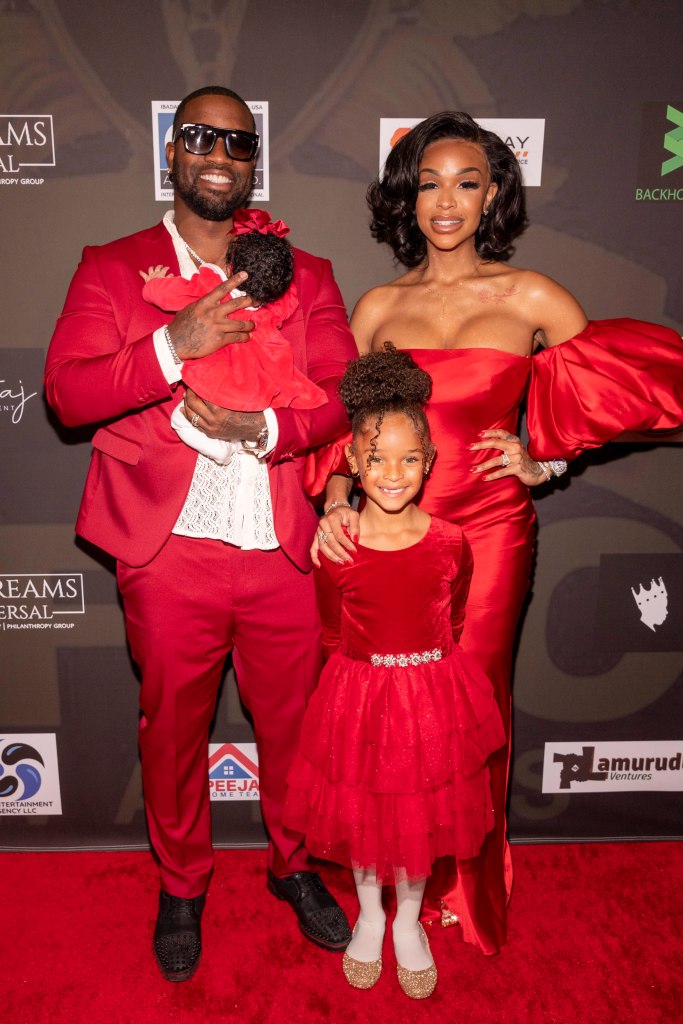 Jamar Champ holding a baby, Amari Hermes, and Khari Barbie Maxwell at the Afro Awards.