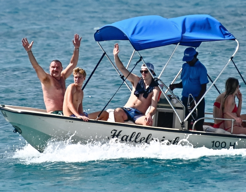 Liev Schreiber and his son on a boat in Barbados.