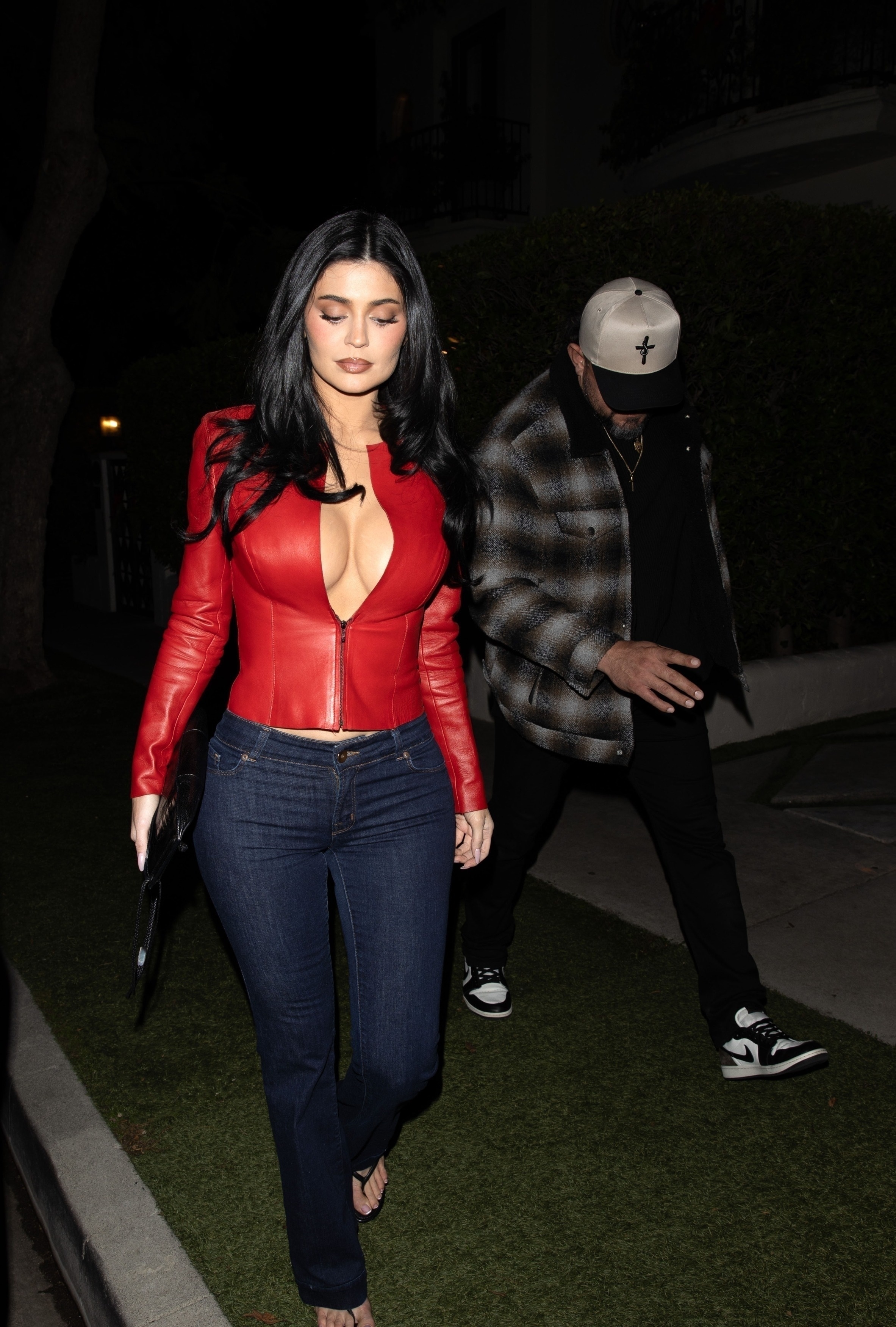 Kylie Jenner wearing a red leather top and denim jeans at the Chrome Hearts party.