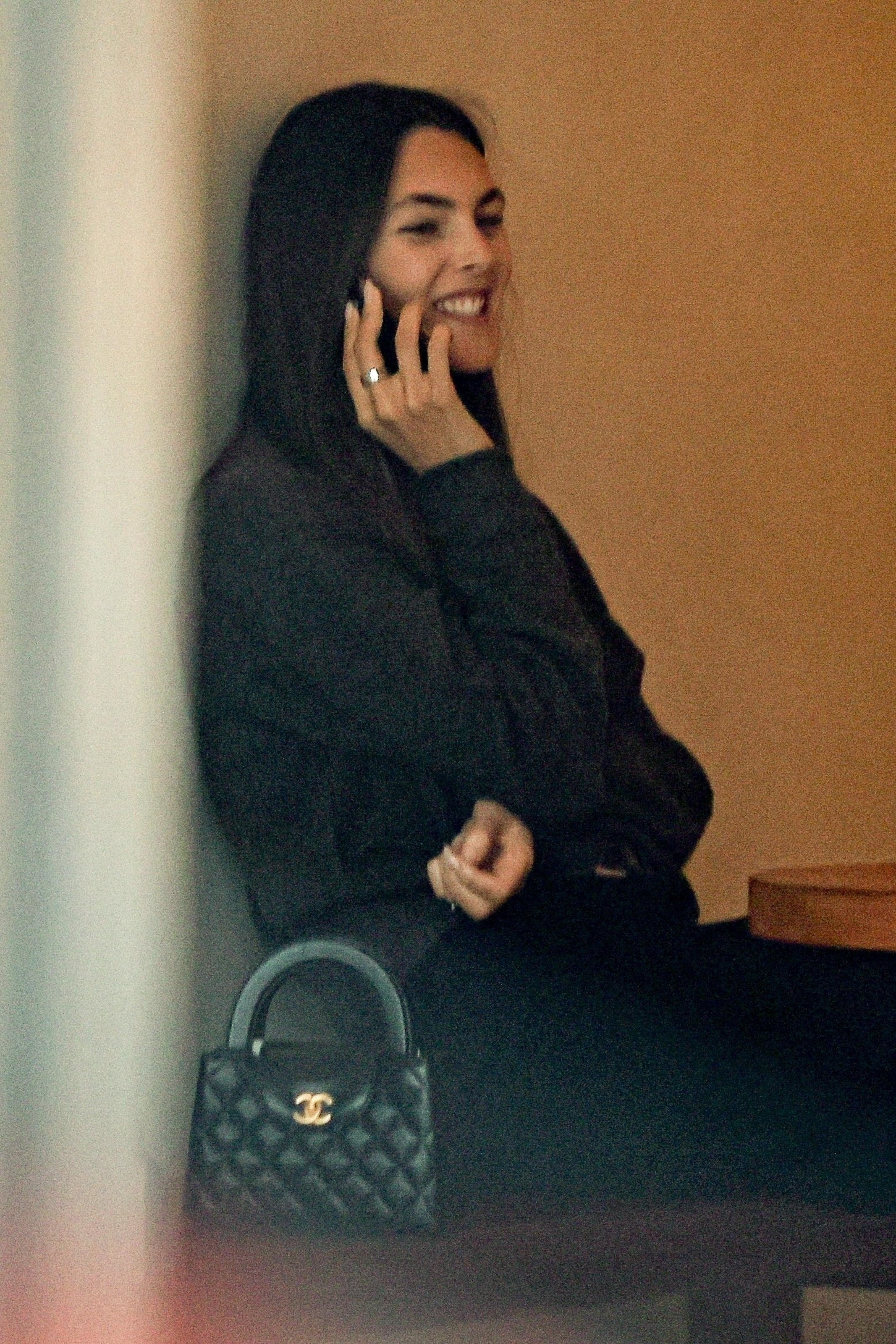 Vittoria Ceretti speaking on the phone and smiling.