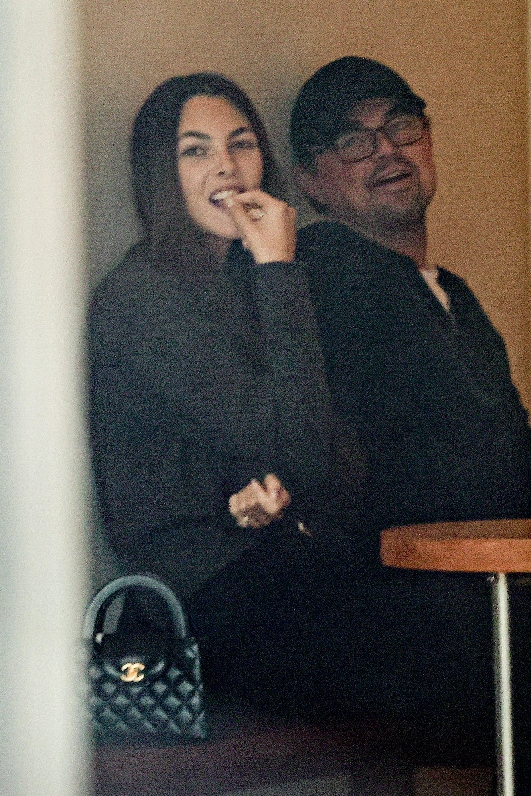 Vittoria Ceretti and Leonardo DiCaprio sharing a meal at a cafe.