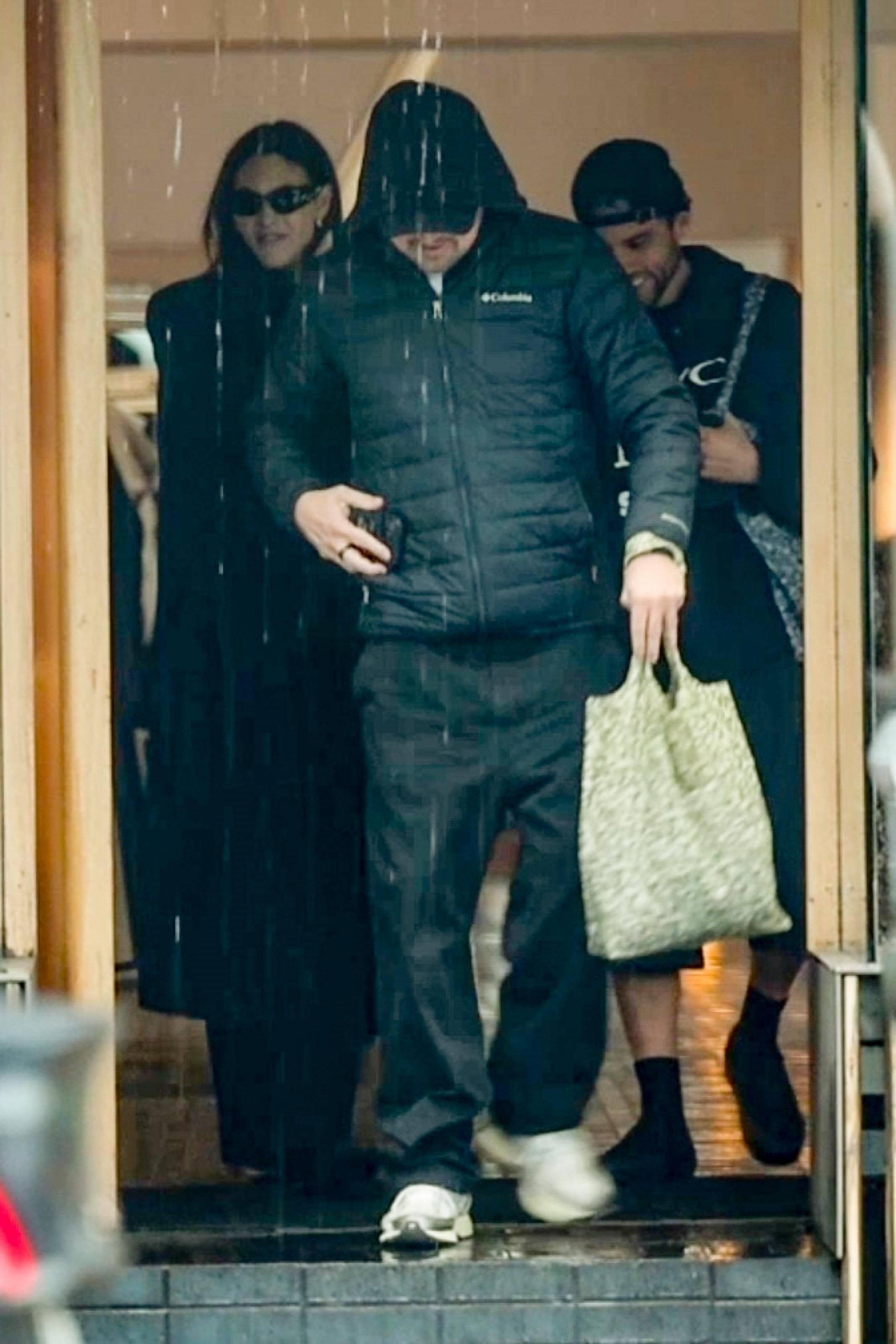 Leonardo DiCaprio and Vittoria Ceretti shopping on a rainy day.