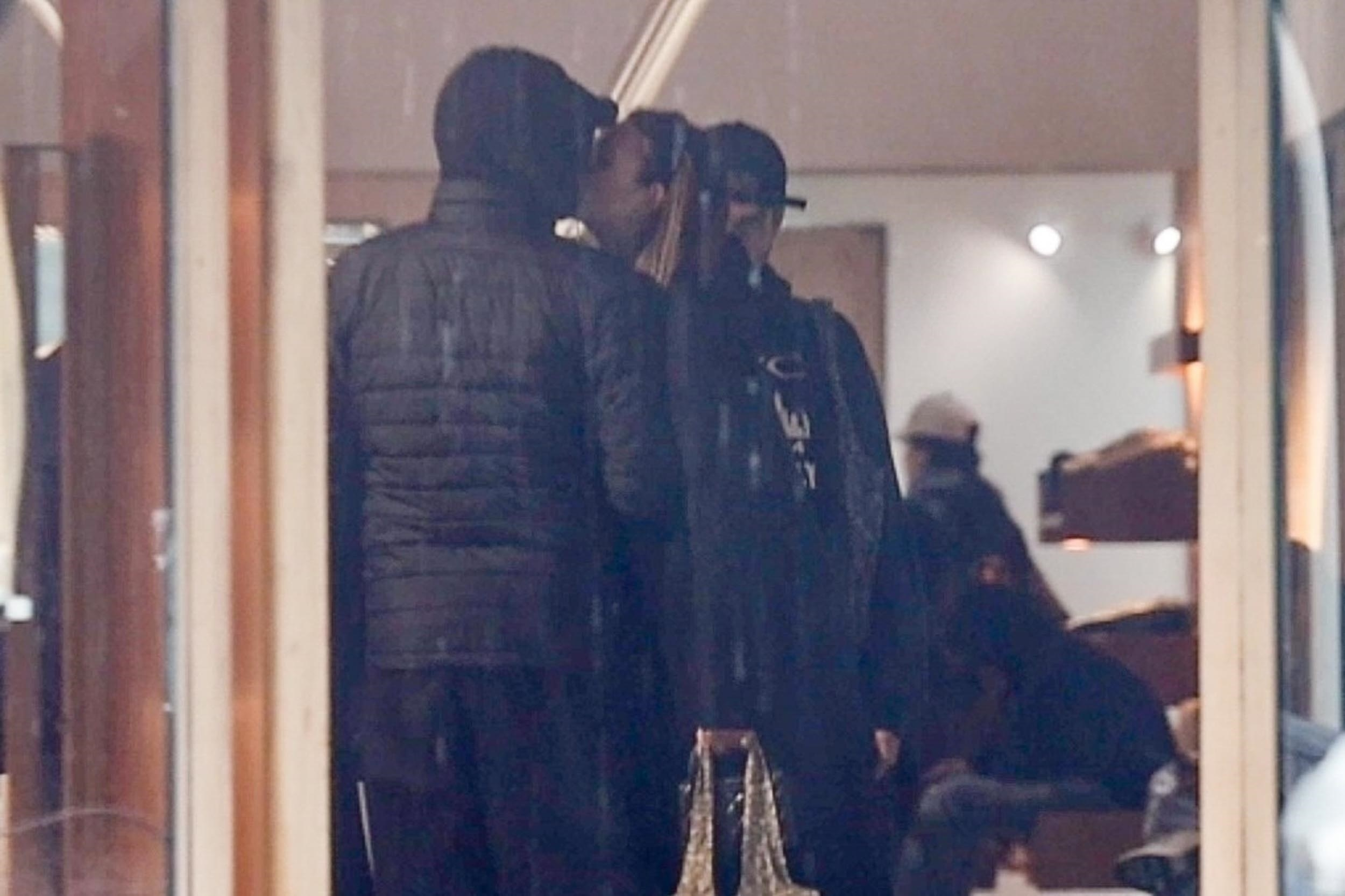 Leonardo DiCaprio and Vittoria Ceretti kissing while shopping.