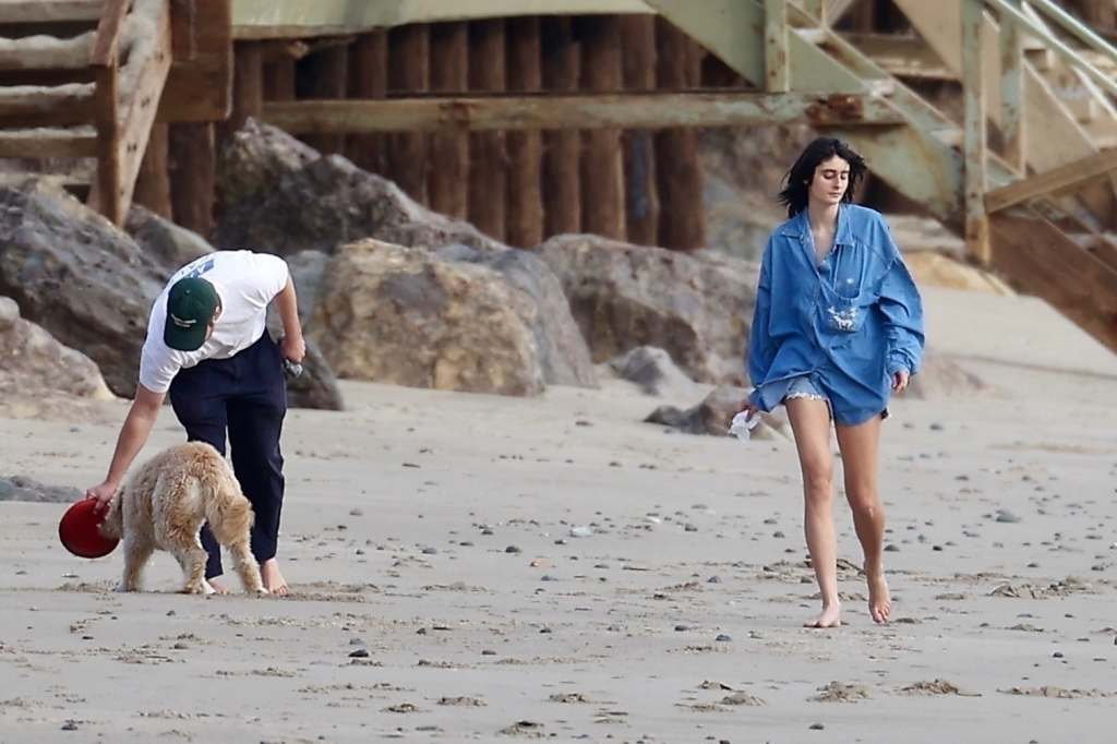 Romy Reiner and Alex Siliberg walking their dog on Malibu beach.