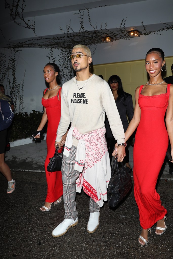 Quincy Brown holds hands with D'Lila Star and Jessie James Combs after attending a Christmas party.