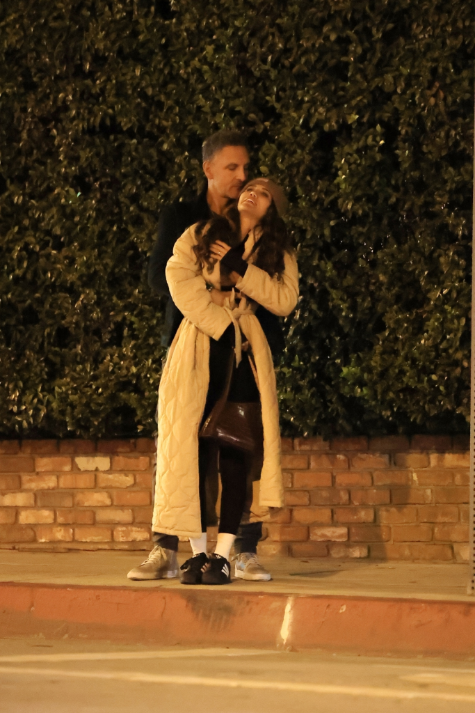 Mauricio Umansky hugging a mystery woman from behind on a street.