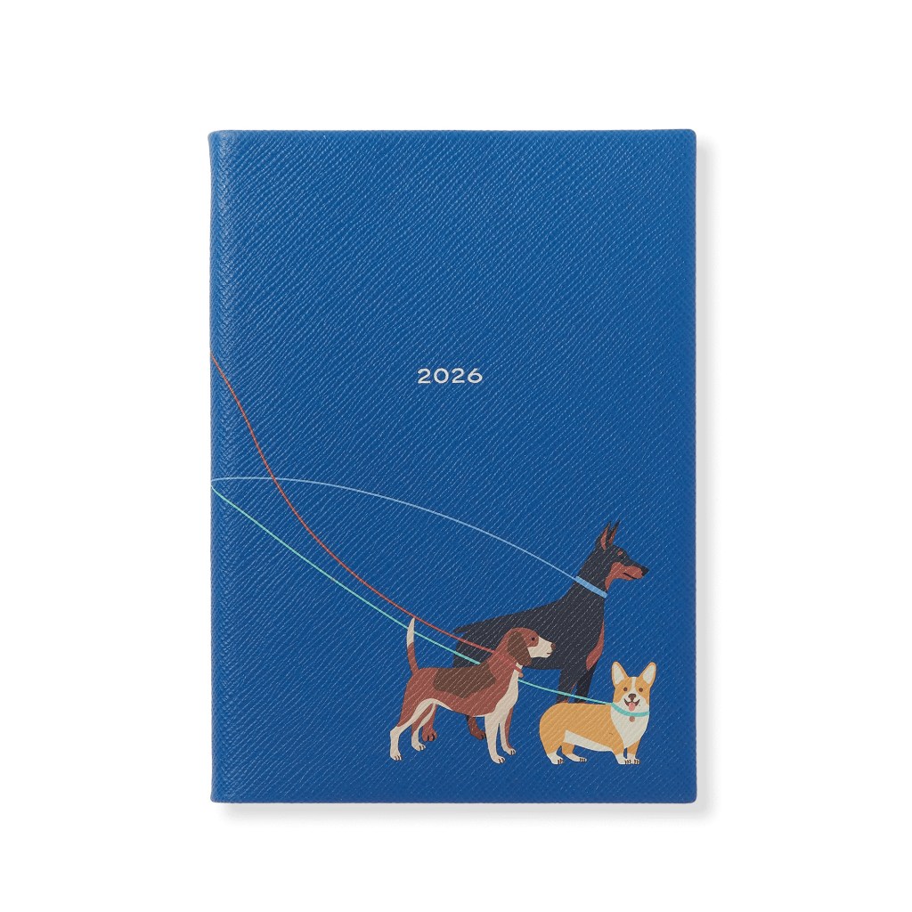 Illustration of a 2026 Soho Weekly Diary with three dogs and their leashes on a blue background.
