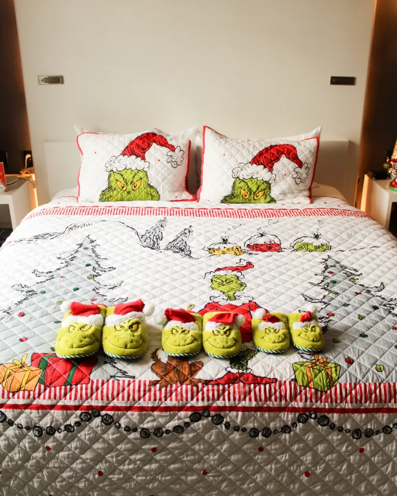 The Grinch themed bed with Grinch slippers.