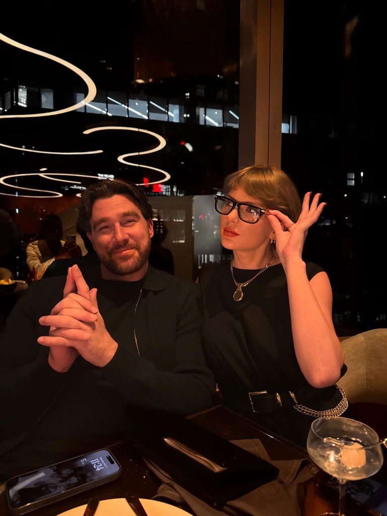 Taylor Swift, in eyeglasses, and Travis Kelce posing for a photo during a dinner outing.