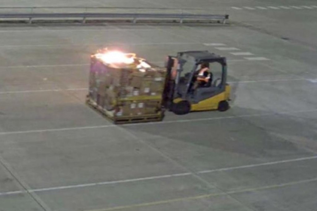 Forklift with burning pallet at a DHL facility.