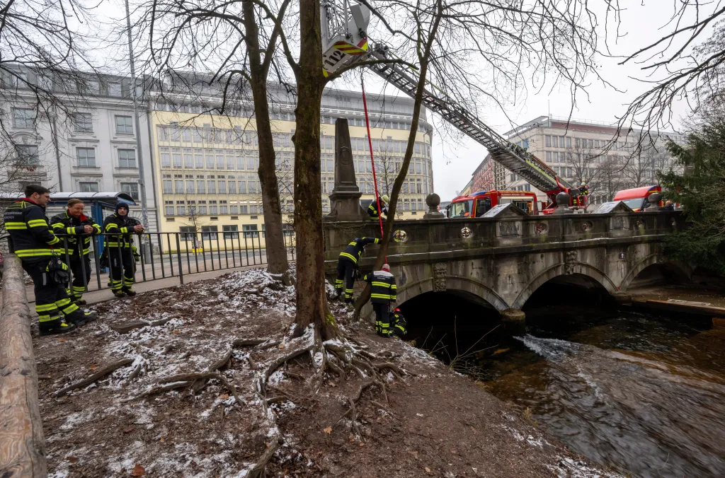 Fire department employees dismantle an artificial wave installation on the Eisbach in Munich, Germany.