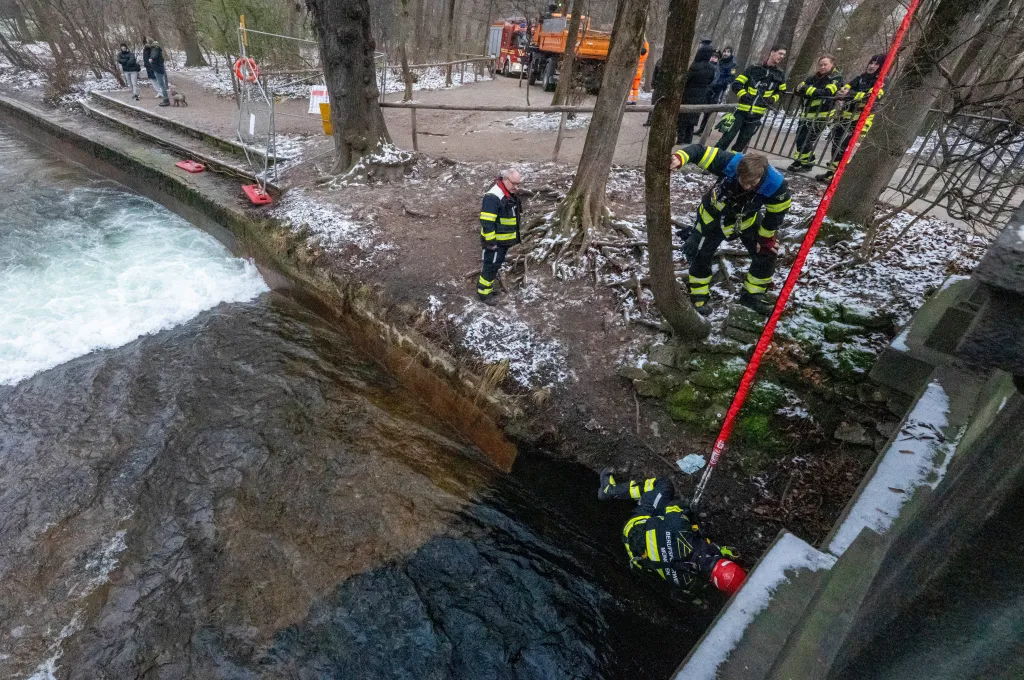 Fire department employees dismantle an artificial wave installation on the Eisbach in Munich, Germany.