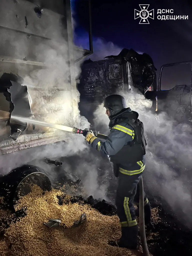 Firefighters extinguish a fire at the site of a Russian missile and drone strike.