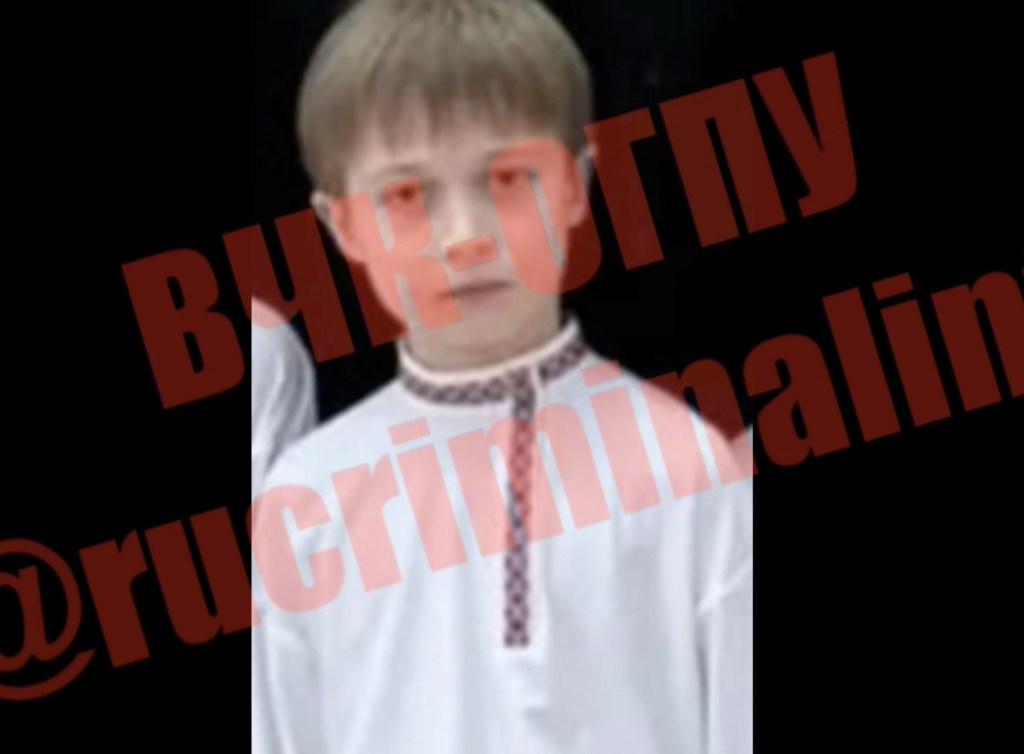 Photo of Ivan Putin, 10, wearing a white shirt with an embroidered collar.