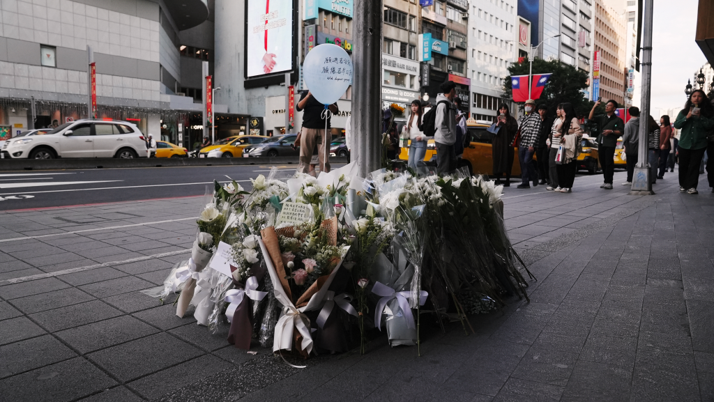 Flowers and notes laid for victims of a metro attack outside a mall in Taipei.