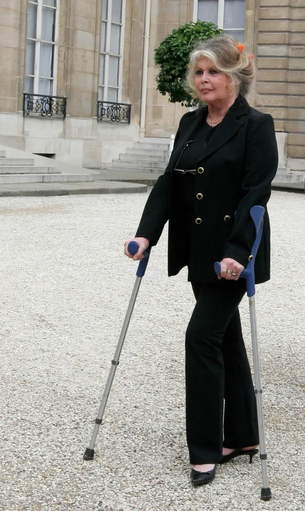 Former actress Brigitte Bardot walks with crutches.