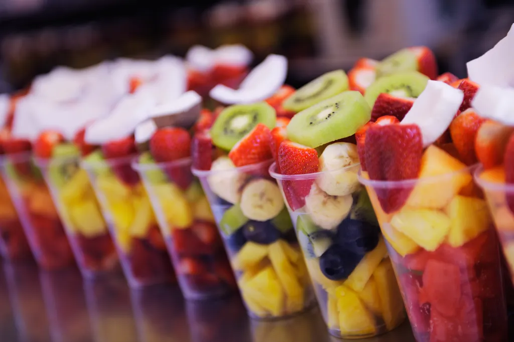Fruit salad to go in clear plastic cups.
