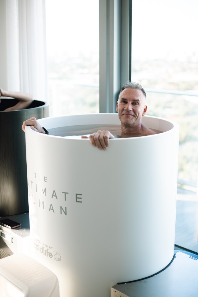 Gary Brecka smiling in a cold therapy tub.
