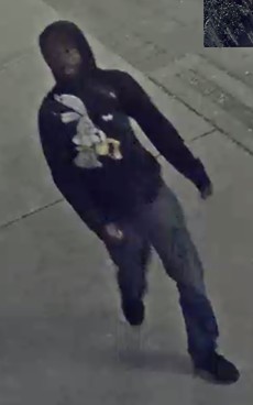 Authorities are searching for a person of interest who was last seen in surveillance footage sporting blue jeans and a dark hooded sweatshirt with a white cartoon rabbit.
