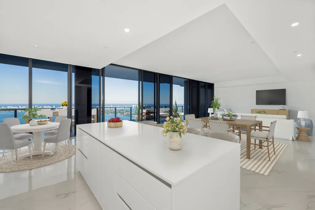 The open kitchen features a casual dining nook and a more formal dining table area