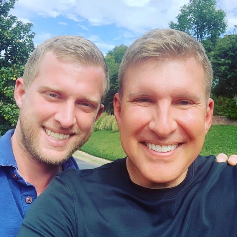 Kyle Chrisley and Todd Chrisley smiling together.