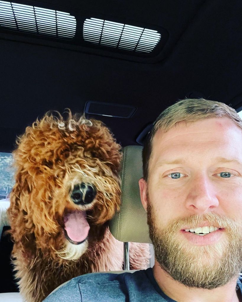 Kyle Chrisley taking a selfie with his dog in the car.