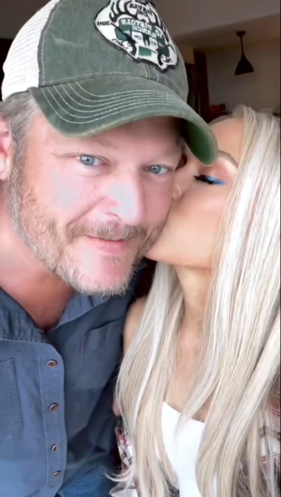 Gwen Stefani kisses Blake Shelton on the cheek.