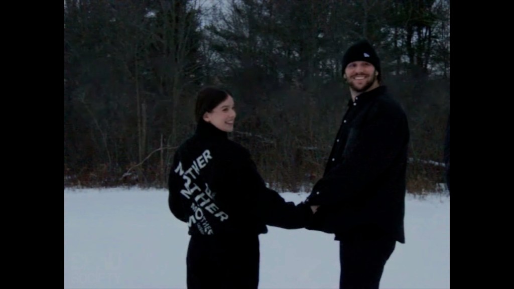 Hailee Steinfeld and Josh Allen holding hands in the snow.