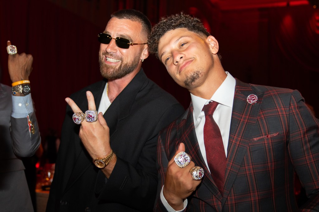 Travis Kelce and Patrick Mahomes of the Kansas City Chiefs posing with their Super Bowl LVII rings.