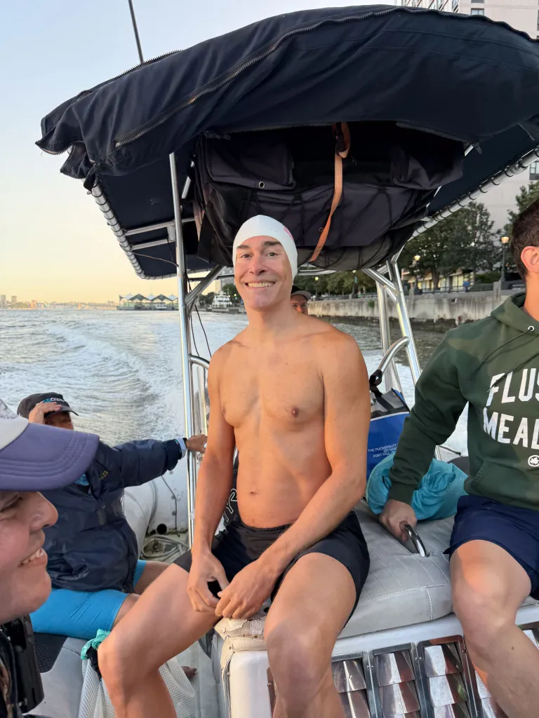 Michael Moreau in his swimsuit on a boat.