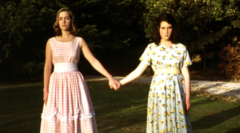 Kate Winslet and Melanie Lynskey holding hands in