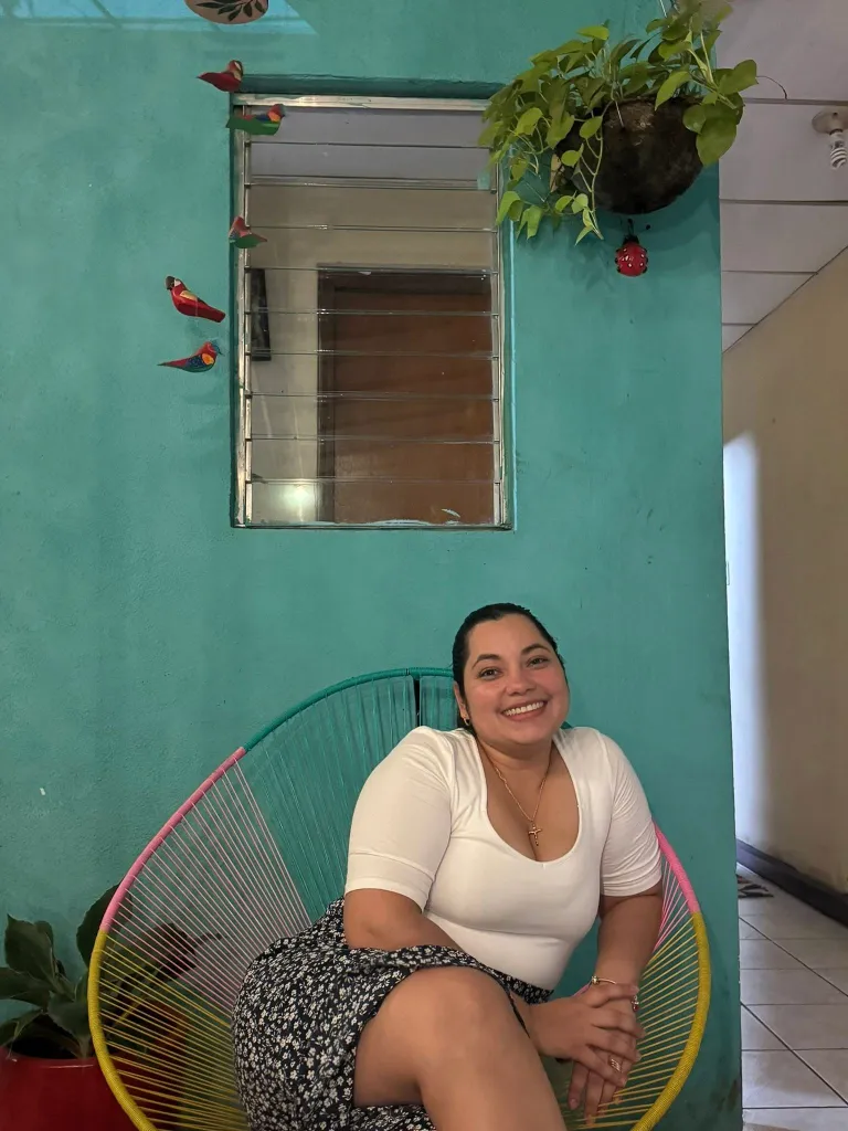 Helen Garay smiles while sitting in a colorful chair.