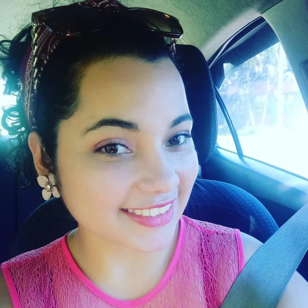 Helen Garay smiling in a car.